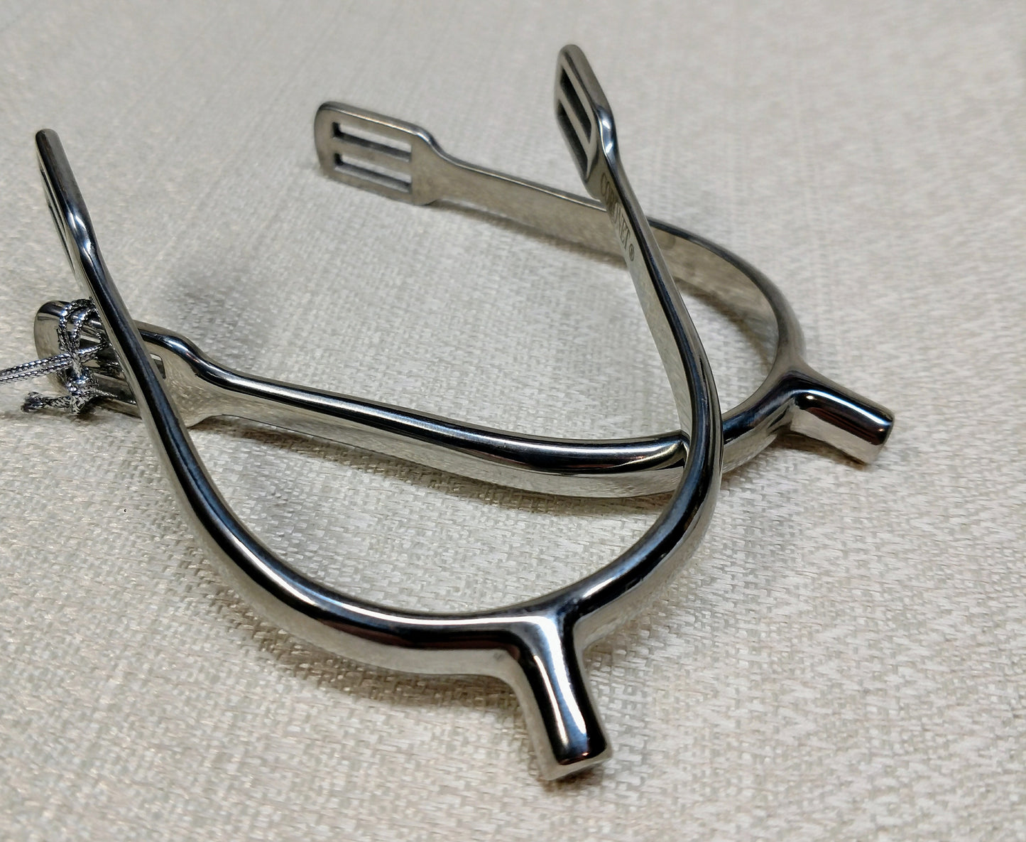 Stainless steel ladies POW spurs with 10mm neck and easy‑insert square‑slot strap design, lightweight and shaped for women riders.