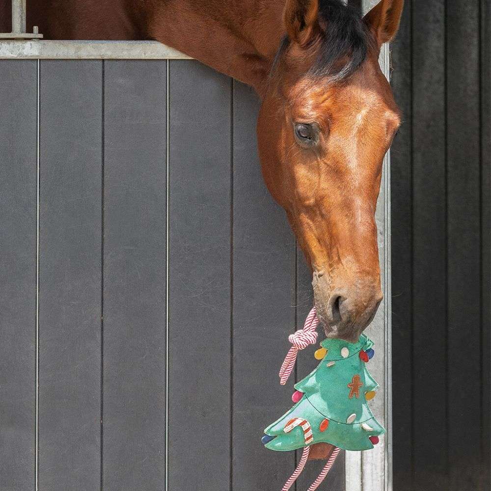 horse playing with christmas tree toy