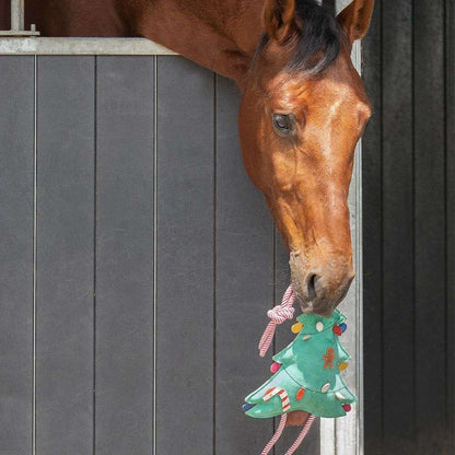 horse playing with christmas tree toy