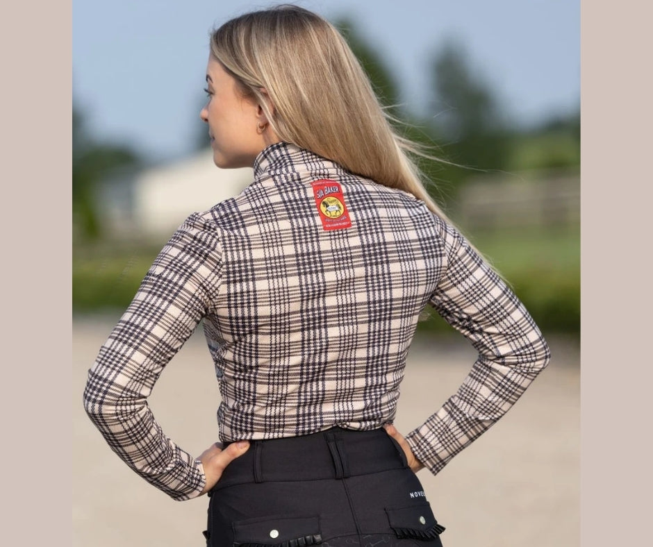 Back view of the Baker × Novella quarter zip featuring the red Baker label on the upper back.