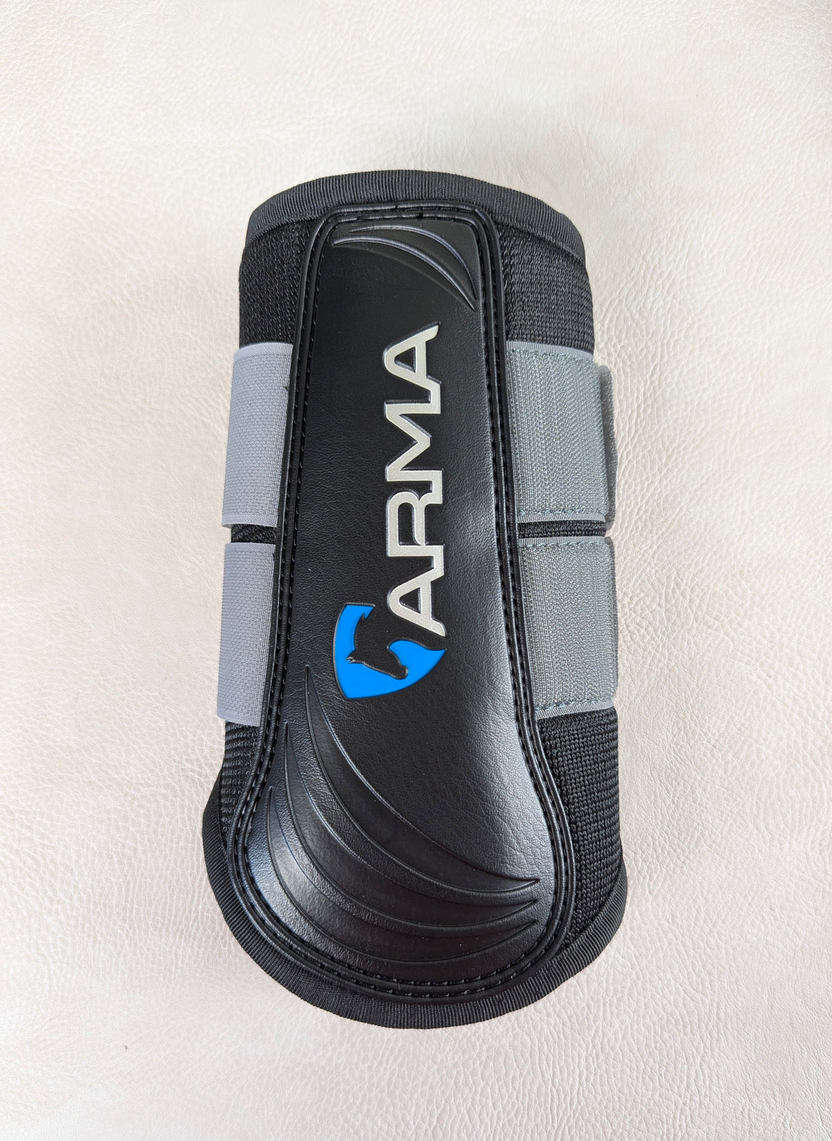 A single black and gray ARMA brushing boot on a light textured background, highlighting the molded strike pad and vertical ARMA logo.