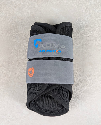 A rolled black ARMA Air Motion brushing boot wrapped in a gray elastic band, showing the breathable mesh material and Air Motion branding.