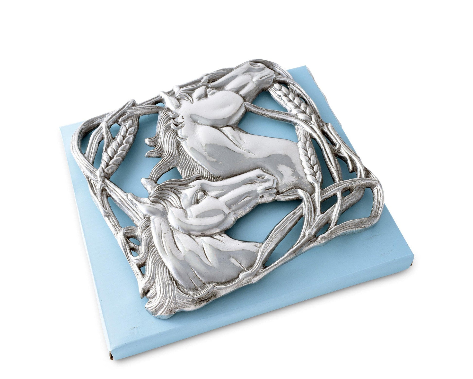 Cast aluminum trivet featuring two sculpted horse heads facing opposite directions, surrounded by an ornate border of intertwined wheat stalks