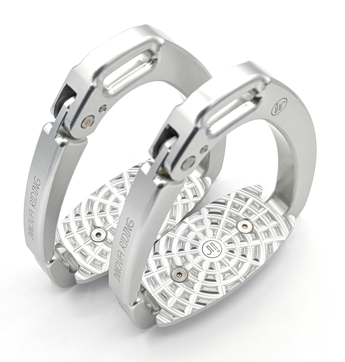 Pair of silver Innova by Tech Stirrups Olympia safety stirrups with geometric aluminum tread and hinged safety arm, displayed in a polished metallic finish.