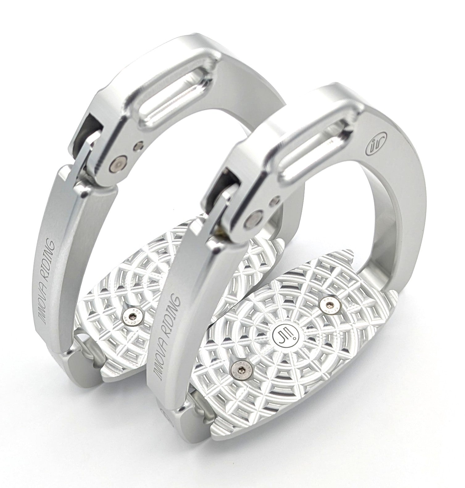 Pair of silver Innova by Tech Stirrups Olympia safety stirrups with geometric aluminum tread and hinged safety arm, displayed in a polished metallic finish.