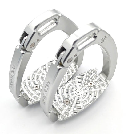Pair of silver Innova by Tech Stirrups Olympia safety stirrups with geometric aluminum tread and hinged safety arm, displayed in a polished metallic finish.
