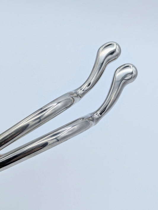 Close‑up of stainless steel swan‑neck spur tips showing the smooth, rounded ends and polished finish.