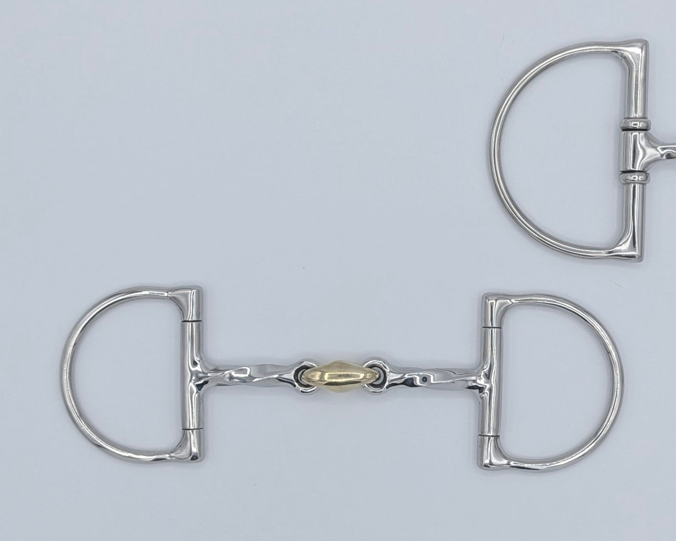 Two Hunter Dee pony bits side by side, one with a brass peanut and one single‑jointed, highlighting differences in cheek size.