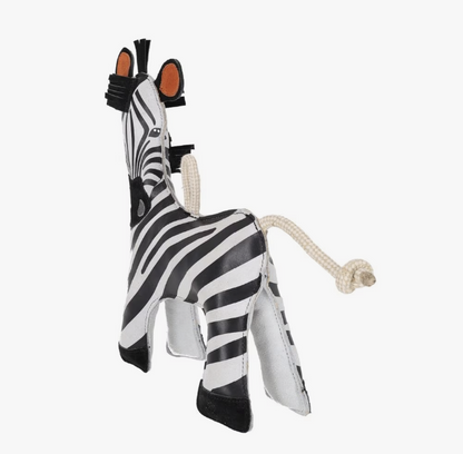 Zebra-shaped horse toy with a rope on a white background.