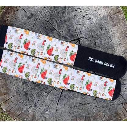 scenic red barn farm life socks on a tree stump