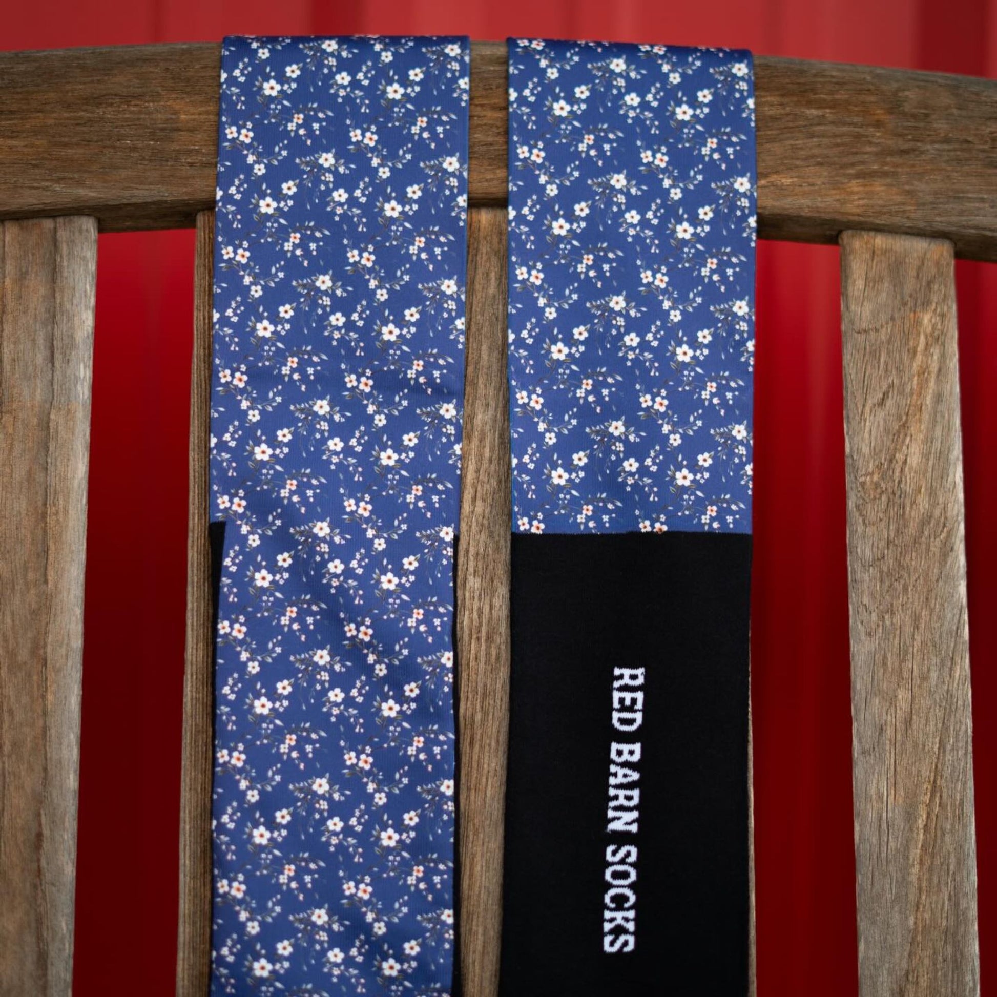 red barn socks with navy background an small flowers