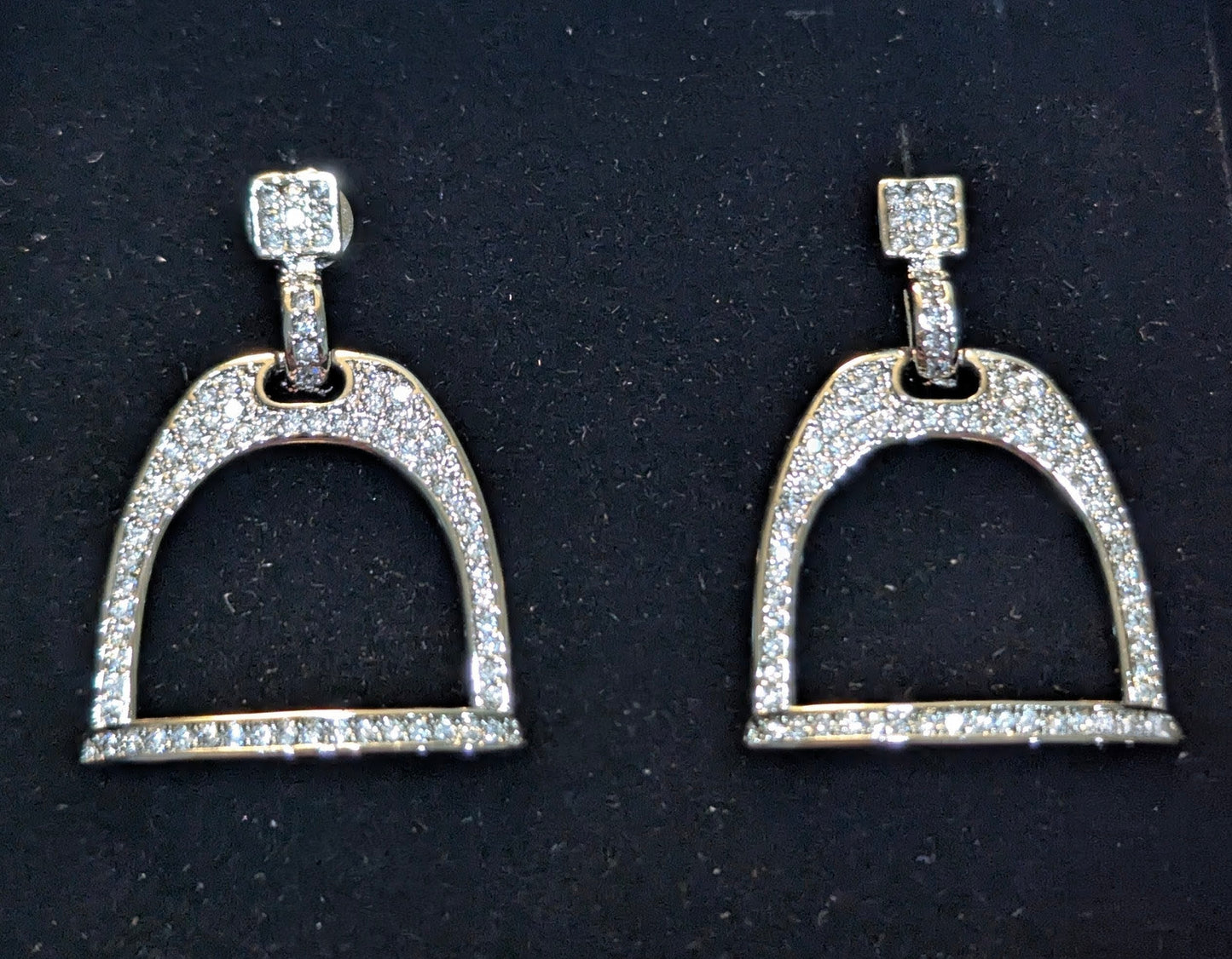 Pair of silver plated english stirrup earrings with pave cz's on a black velvet background