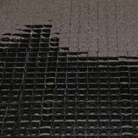 Close-up of Stall Grid panel partially covered with back filled material.