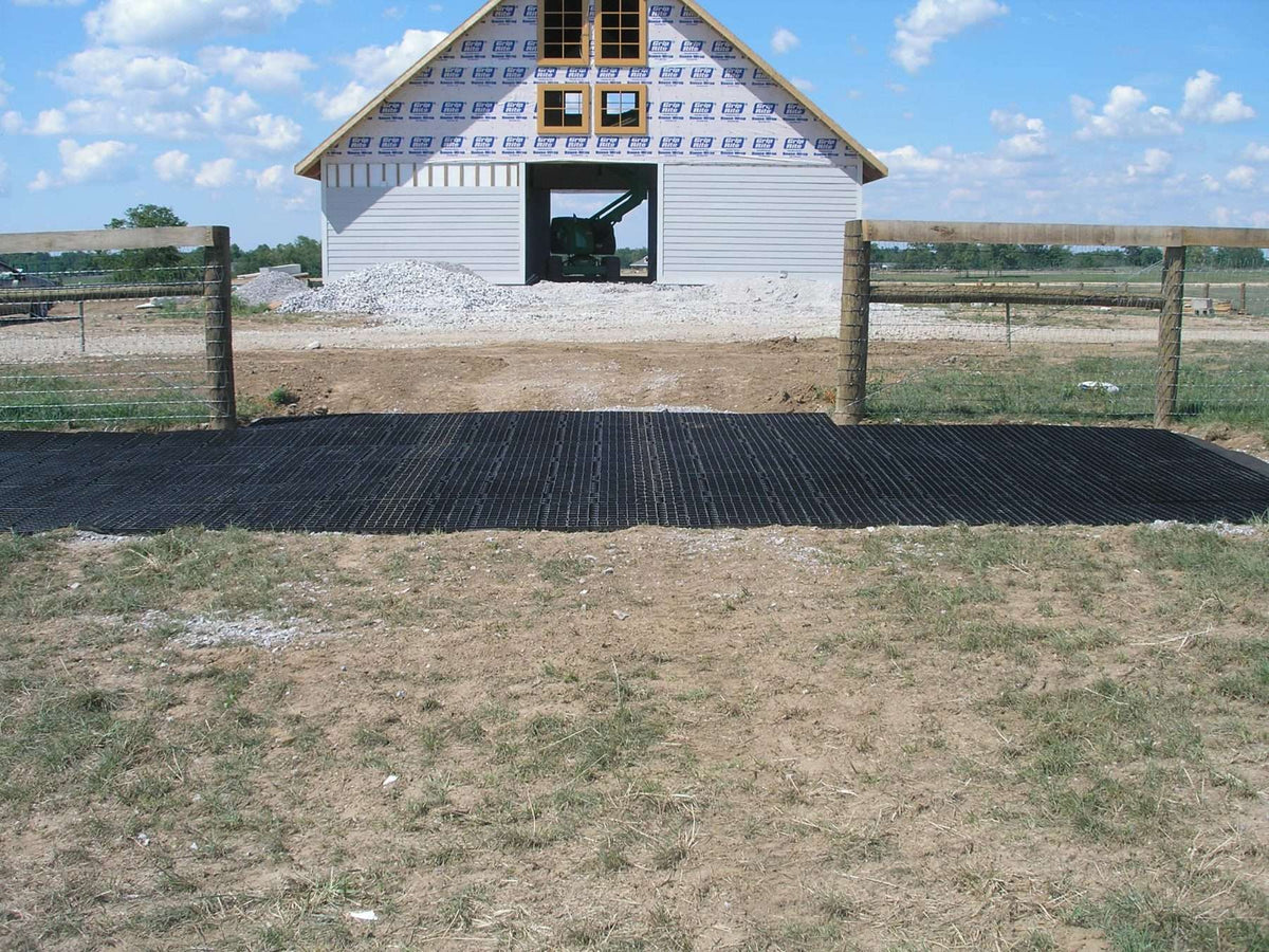 Stall Grid used in a muddy farm access point to create a durable, well‑drained surface for horses, tractors, and daily traffic.
