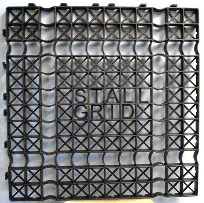 Interlocking Stall Grid flooring panel showing structural cross‑supports and raised “STALL GRID” logo.