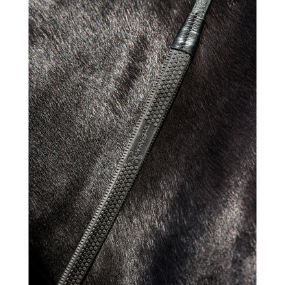 Close-up of Trust 1/2" Samorin rubber rein featuring premium Kris rubber grip and leather detailing against a horse's coat.