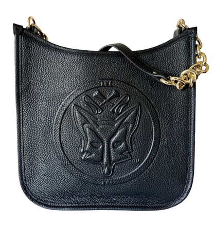 Black Tucker Tweed Middleburg Messenger purse shown upright on a neutral background, featuring the embossed equestrian emblem on the front, gold chain strap, and textured pebble‑grain leather.