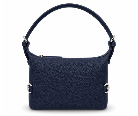 Navy Tucker Tweed Bethany Bit Bag in pebbled Togo leather with a structured silhouette, silver hardware, and top zipper, shown standing upright against a neutral background.