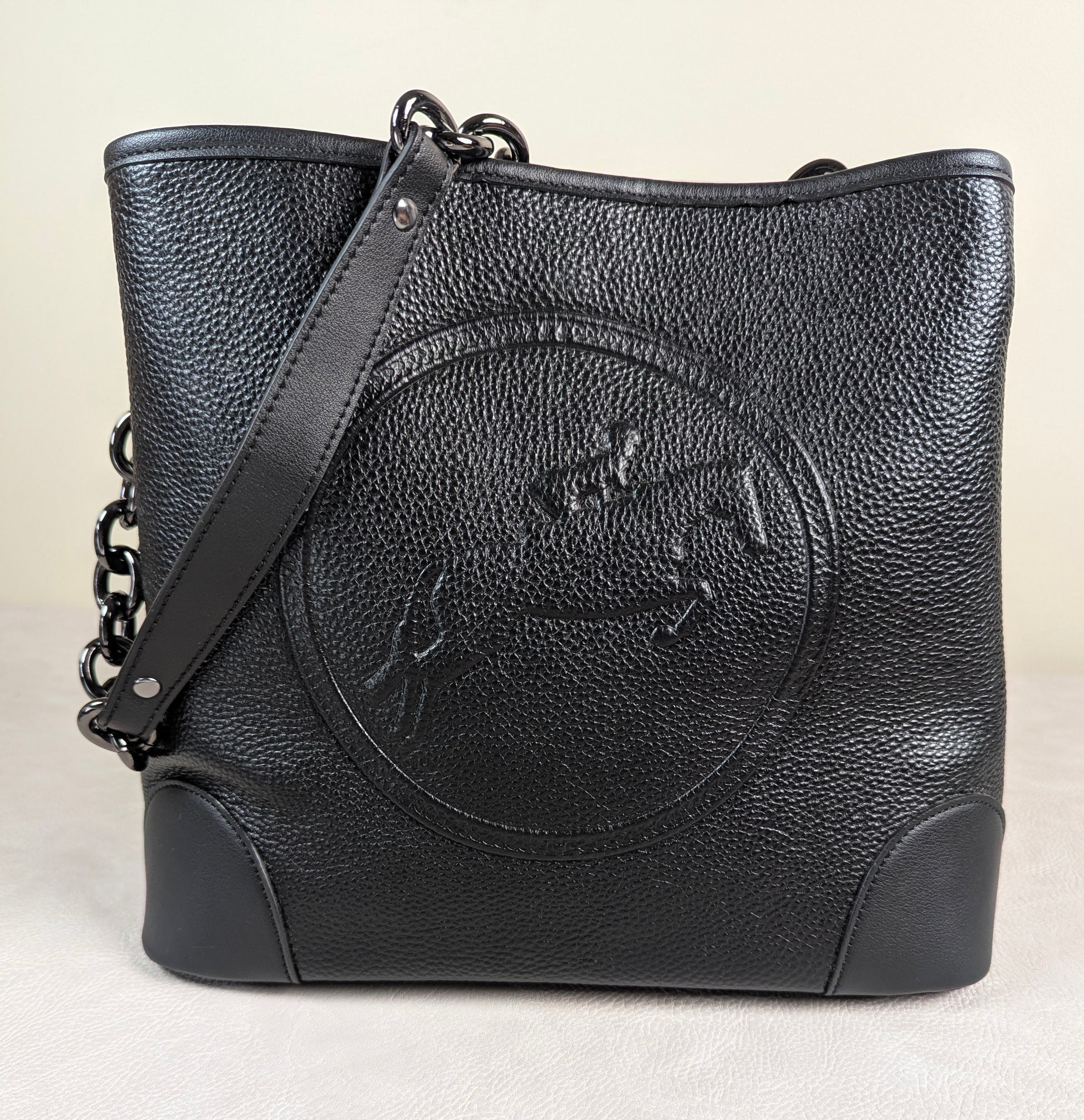black hunter jumper leather bucket bag made by tucker tweed with chain strap and white background