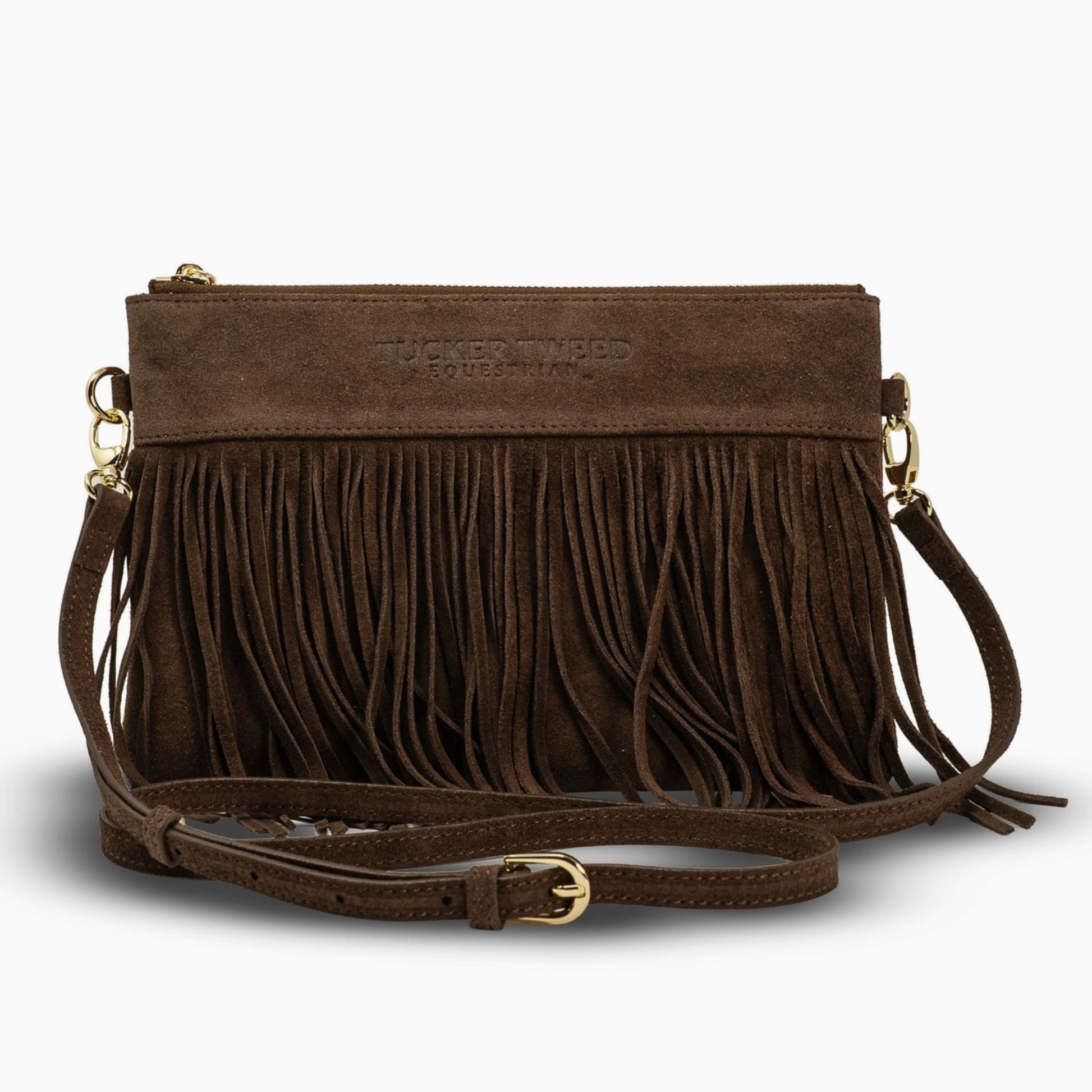A brown suede crossbody clutch bag with a long fringe front, gold-tone hardware, and a matching adjustable shoulder strap, shown on a light gray background.